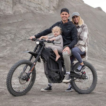 Christopher Glenn Osmond took a picture on a motorbike with his wife and child.